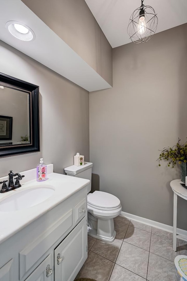 bathroom with tile patterned flooring, vanity, and toilet