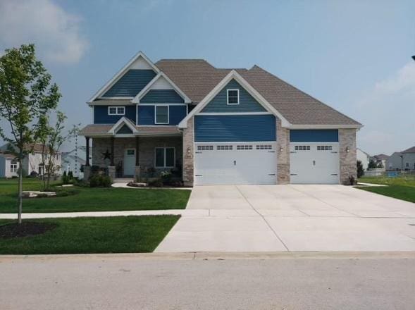 craftsman inspired home featuring a garage and a front yard