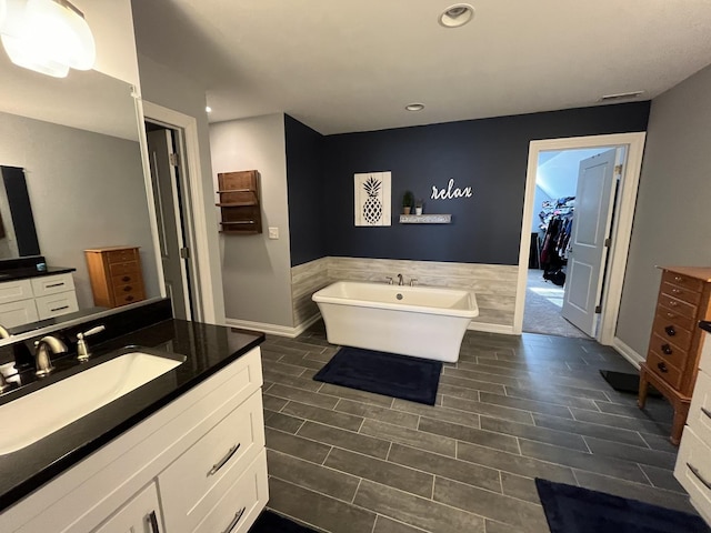 bathroom with vanity and a bathtub