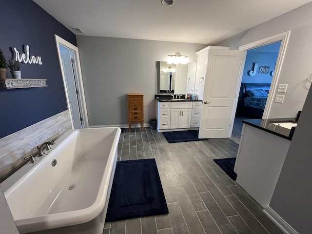 bathroom with vanity and a bathing tub