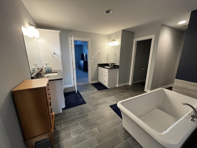 bathroom featuring a bathing tub and vanity