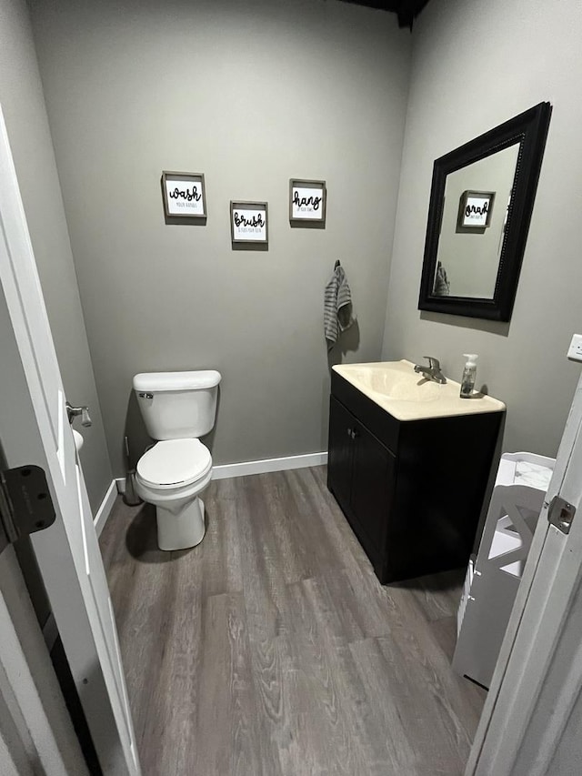 bathroom featuring hardwood / wood-style floors, vanity, and toilet