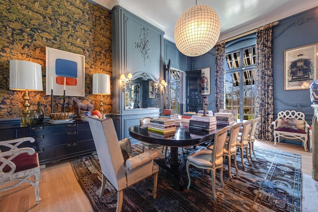 dining area featuring light wood-style flooring and a notable chandelier