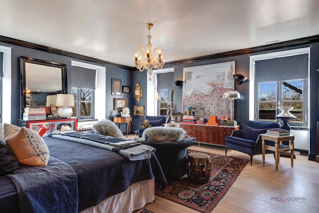 bedroom featuring ornamental molding, light wood-type flooring, and a notable chandelier