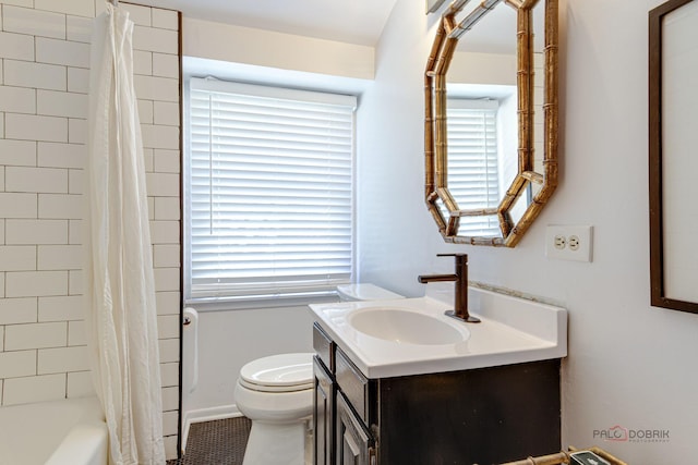 full bath featuring toilet, a healthy amount of sunlight, shower / tub combo with curtain, and vanity