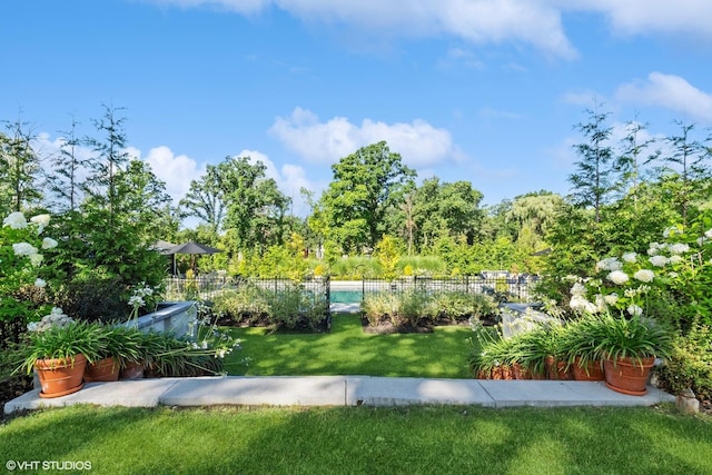 exterior space featuring a lawn and fence