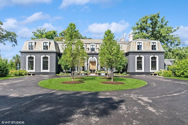 victorian home featuring aphalt driveway, a high end roof, and mansard roof