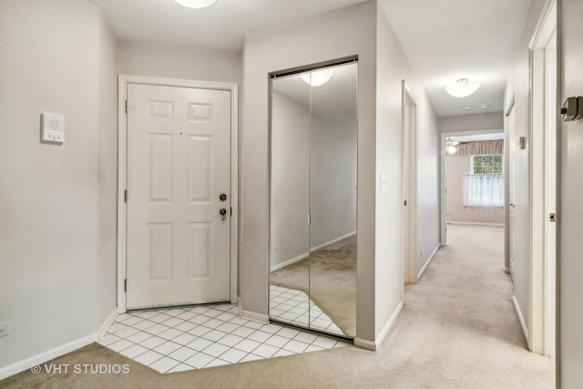 hall featuring light colored carpet