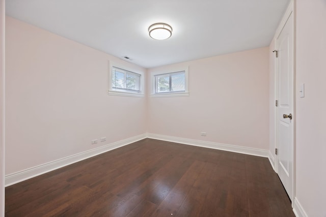 spare room featuring dark hardwood / wood-style floors