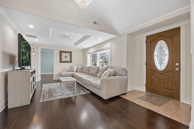 entrance foyer with ornamental molding, dark hardwood / wood-style flooring, and a notable chandelier