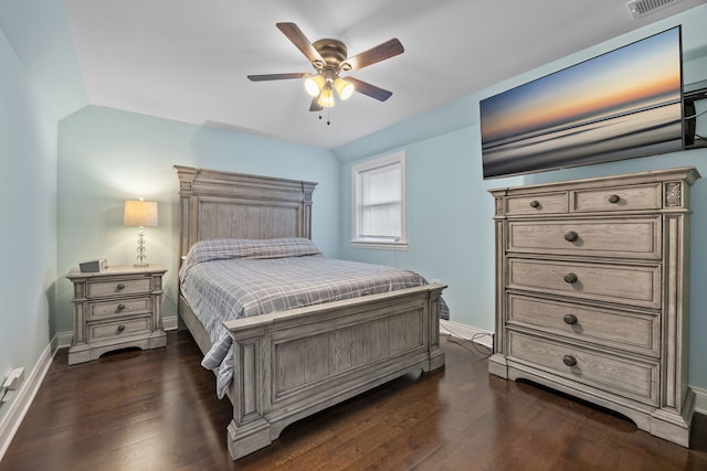 bedroom featuring dark hardwood / wood-style floors, vaulted ceiling, and ceiling fan