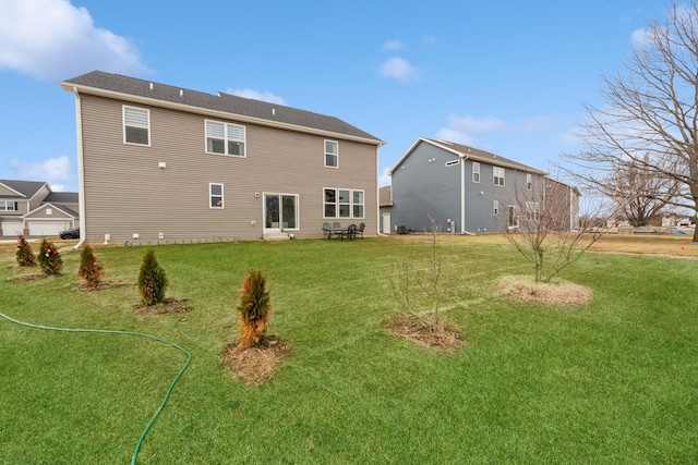 rear view of property with a yard