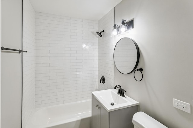 full bathroom featuring vanity, toilet, and tiled shower / bath