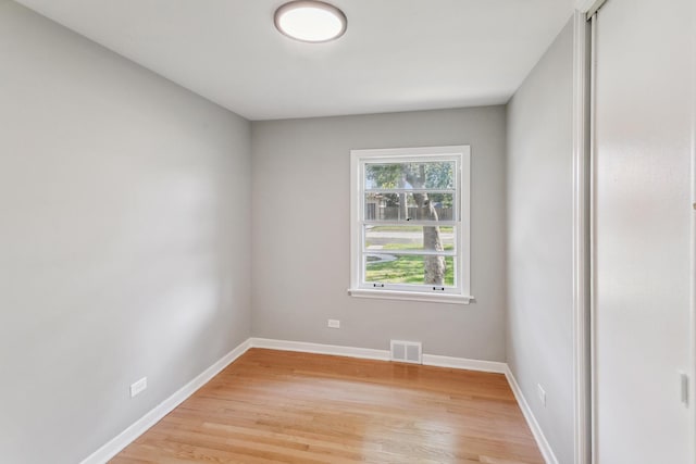 empty room with light hardwood / wood-style floors