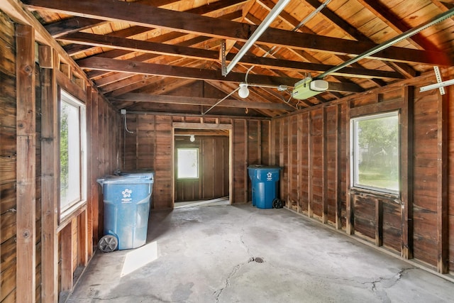 interior space featuring concrete flooring, a wealth of natural light, and lofted ceiling with beams