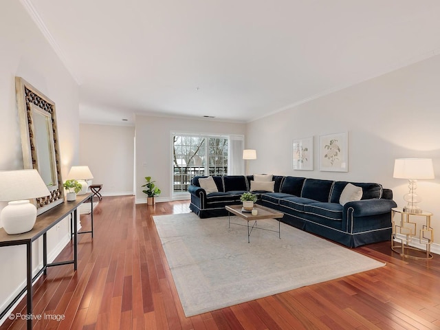 living room with hardwood / wood-style flooring and crown molding