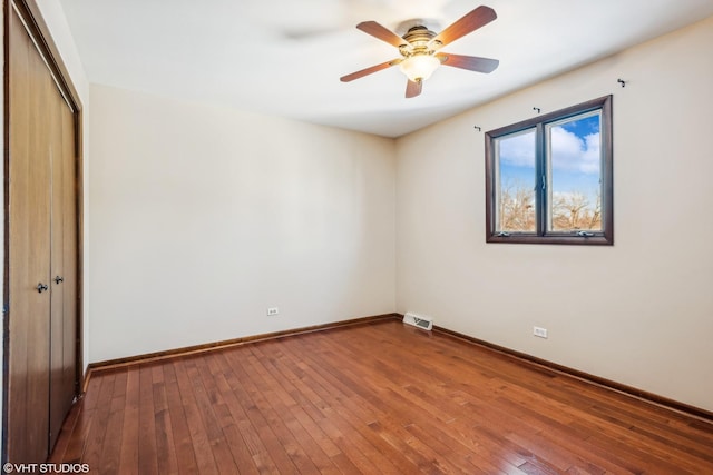 unfurnished room featuring ceiling fan and hardwood / wood-style flooring