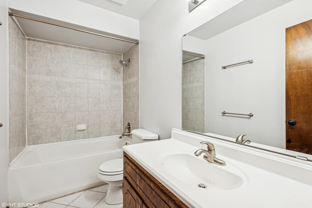 full bathroom featuring toilet, tile patterned flooring, tiled shower / bath, and vanity