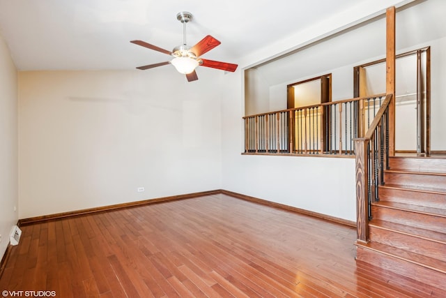 unfurnished living room featuring ceiling fan and hardwood / wood-style flooring