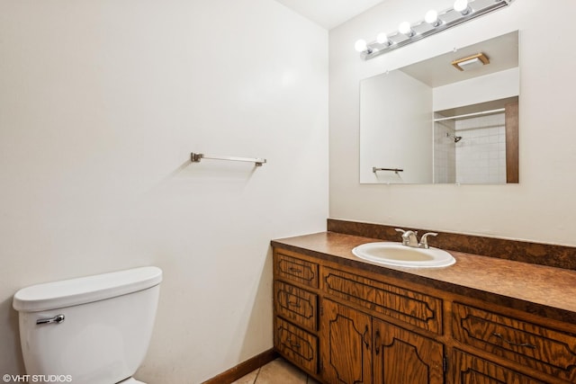 bathroom featuring toilet, vanity, tile patterned flooring, and a shower