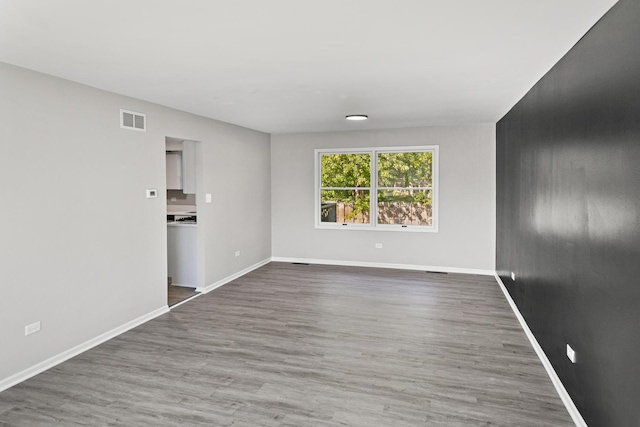 unfurnished room featuring dark hardwood / wood-style floors