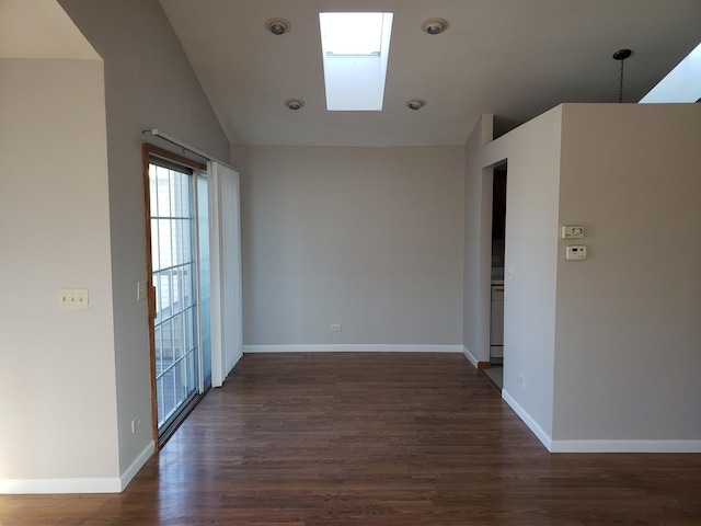 empty room with dark hardwood / wood-style flooring and lofted ceiling with skylight