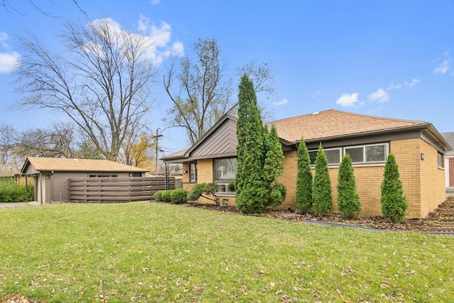 exterior space with an outdoor structure and a yard