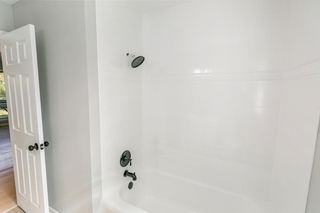 bathroom featuring wood-type flooring and tub / shower combination