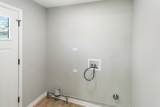 laundry area with hookup for a washing machine, light hardwood / wood-style floors, and electric dryer hookup