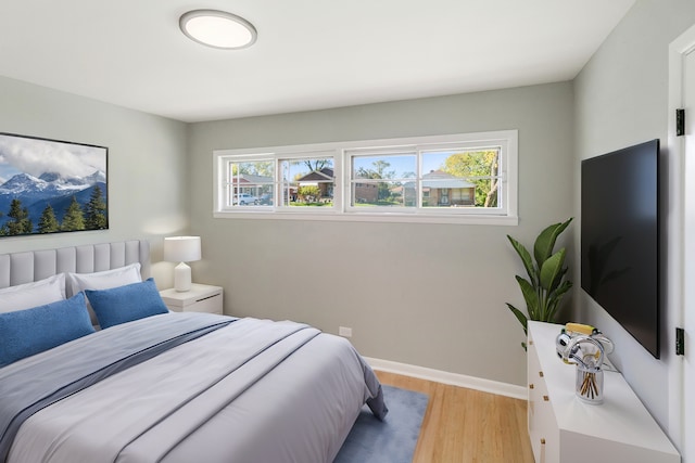 bedroom featuring light hardwood / wood-style floors and multiple windows