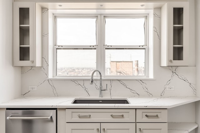 kitchen with white cabinetry, sink, dishwasher, tasteful backsplash, and light stone counters