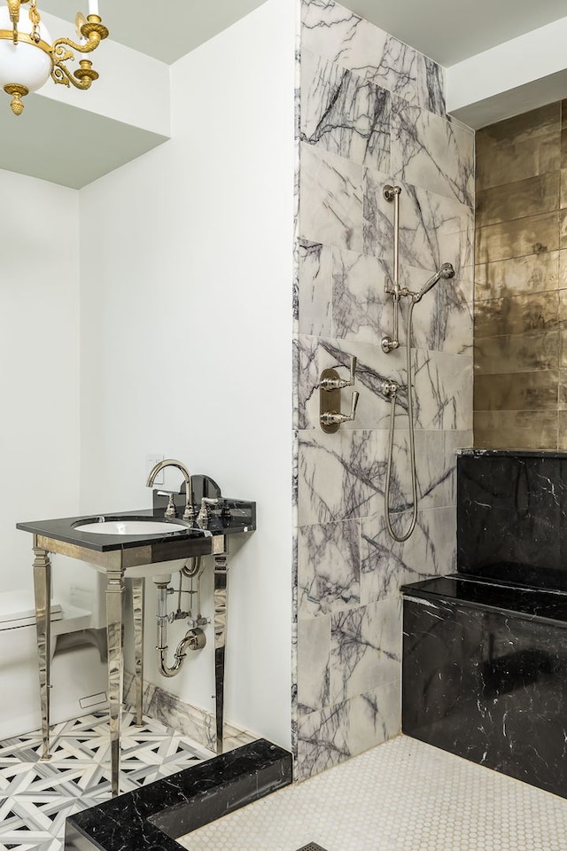 bathroom featuring tile patterned floors, walk in shower, and sink