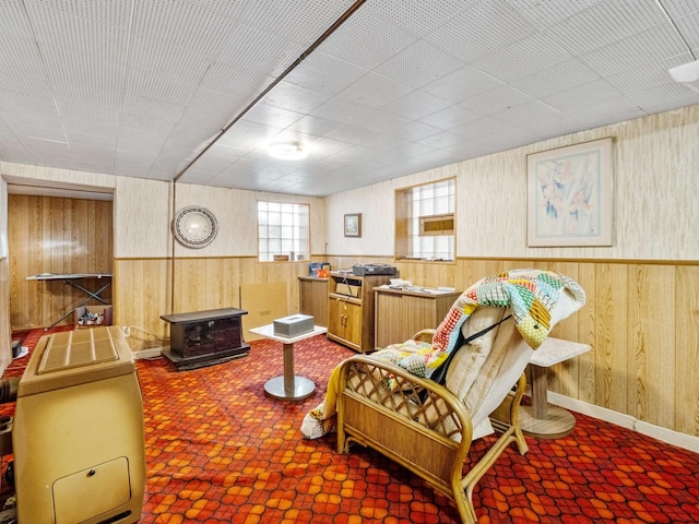 sitting room featuring wooden walls