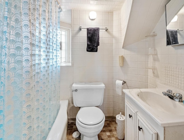 bathroom featuring vanity, toilet, and tile walls