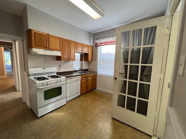 kitchen featuring white appliances and sink