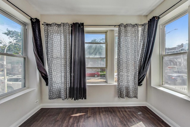 empty room featuring dark hardwood / wood-style flooring