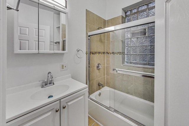 bathroom featuring vanity and shower / bath combination with glass door