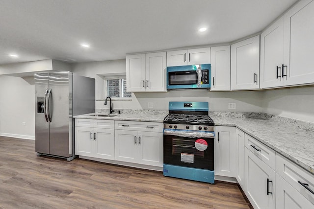 kitchen featuring sink, white cabinets, and appliances with stainless steel finishes