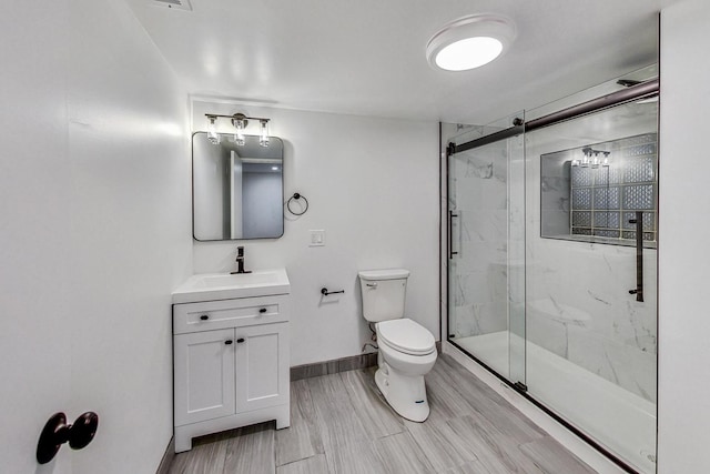 bathroom with vanity, toilet, and an enclosed shower