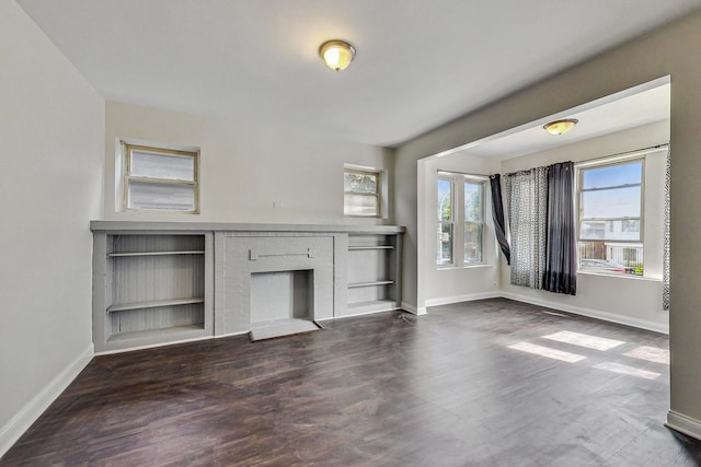 unfurnished living room featuring dark wood-type flooring