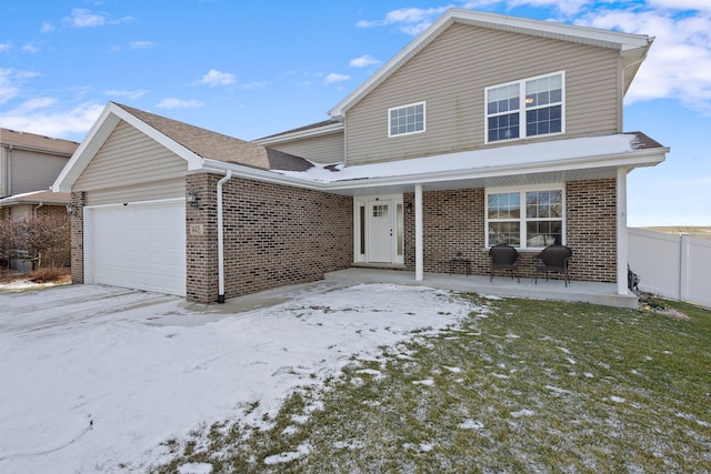 view of property featuring a porch and a garage