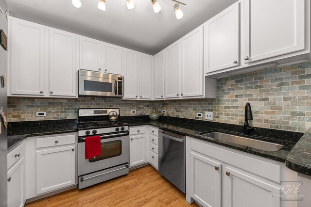 1111 S Wabash Ave Unit 808, Chicago, IL 60605 - kitchen featuring backsplash, sink, appliances with stainless steel finishes, light hardwood / wood-style floors, and white cabinetry
