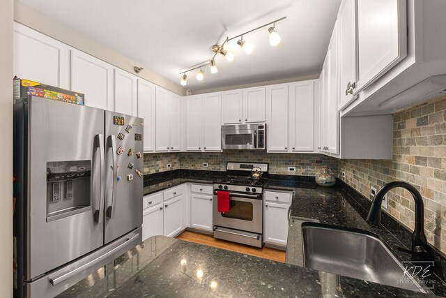 1111 S Wabash Ave Unit 808, Chicago, IL 60605 - kitchen with white cabinets, sink, dark stone countertops, tasteful backsplash, and stainless steel appliances