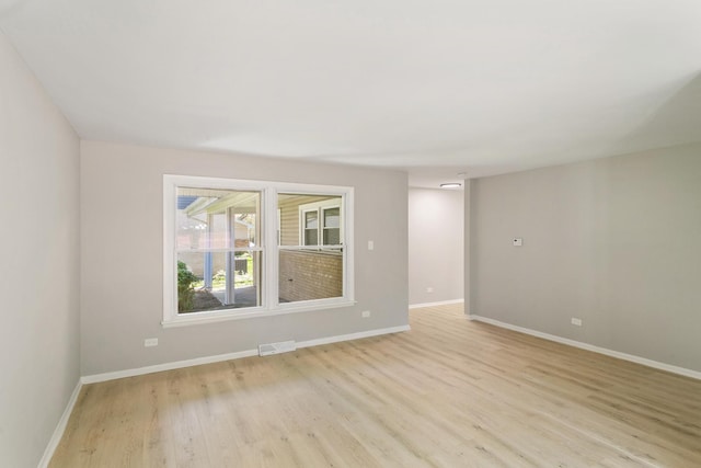 empty room with light hardwood / wood-style flooring