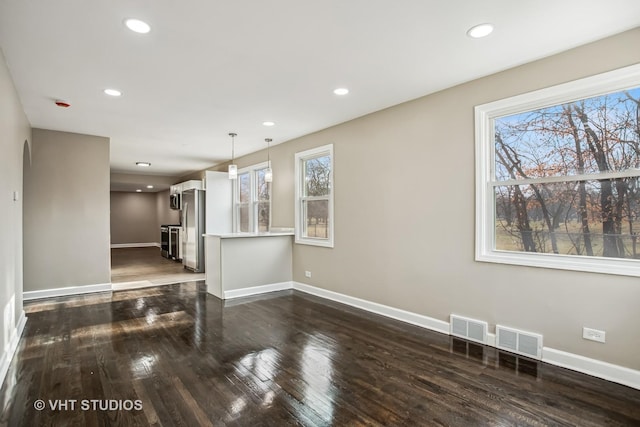 unfurnished living room featuring dark wood-type flooring