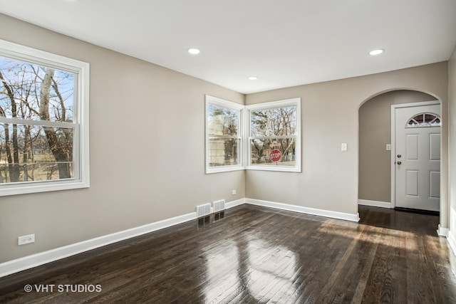 unfurnished room featuring dark wood-type flooring