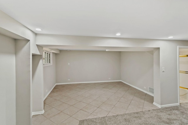 basement featuring light tile patterned flooring