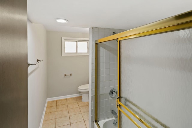 bathroom featuring toilet, tile patterned floors, and enclosed tub / shower combo