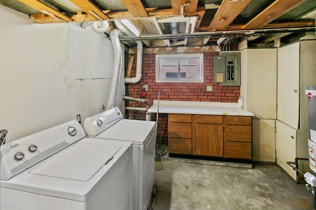 clothes washing area featuring electric panel, cabinets, and independent washer and dryer