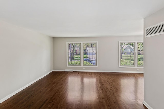 spare room featuring dark hardwood / wood-style flooring